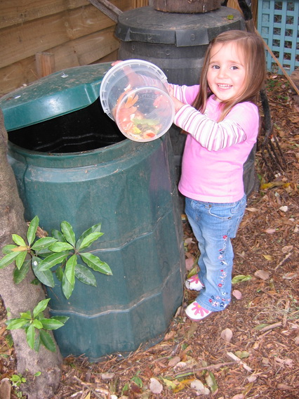 adding kitchen scraps to compost